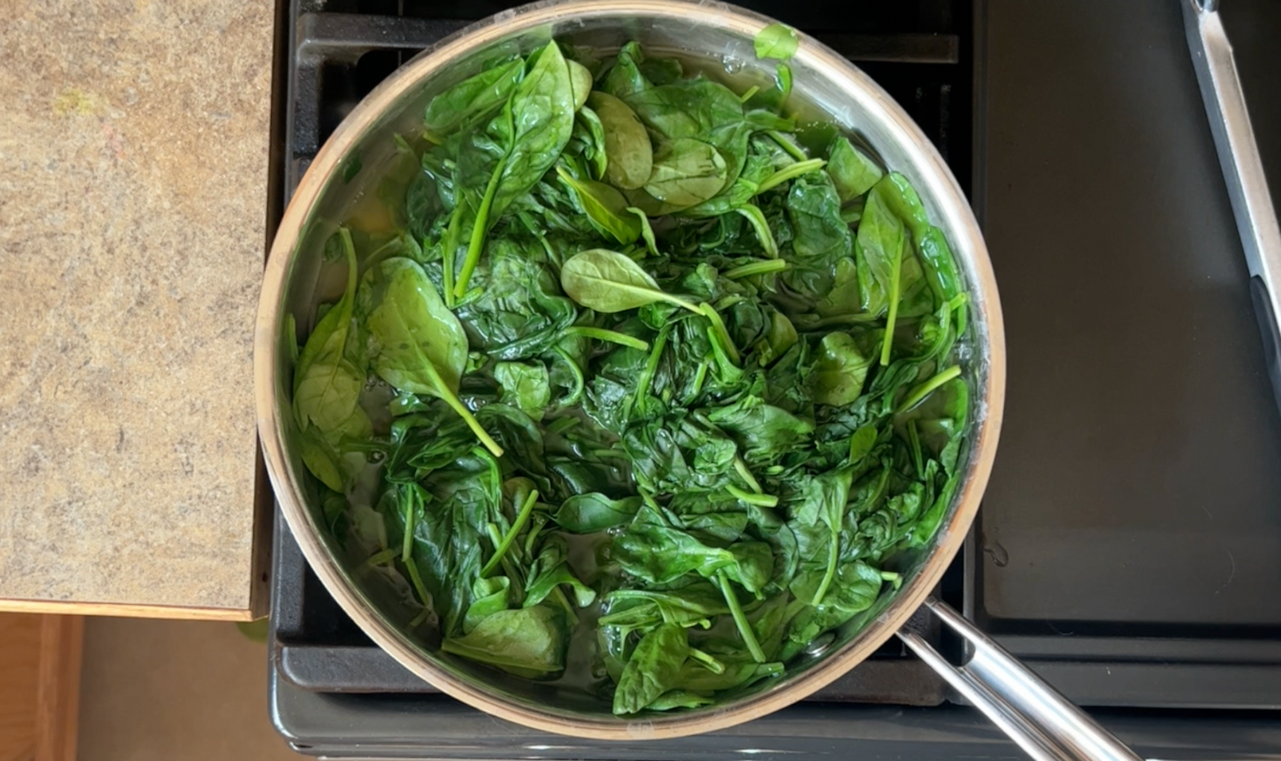 Spinach wilting in a pan