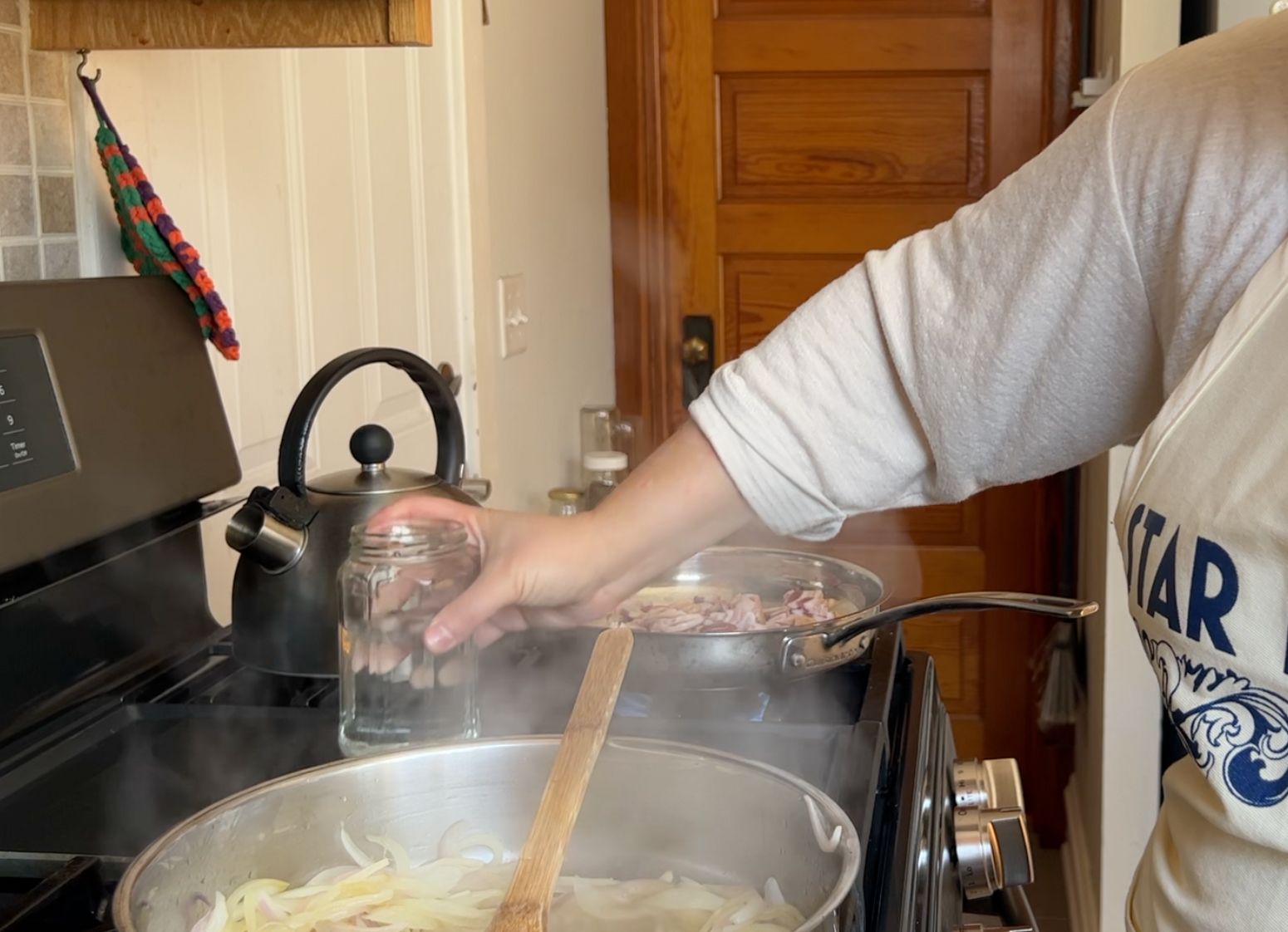 Pouring water into the cooking onions