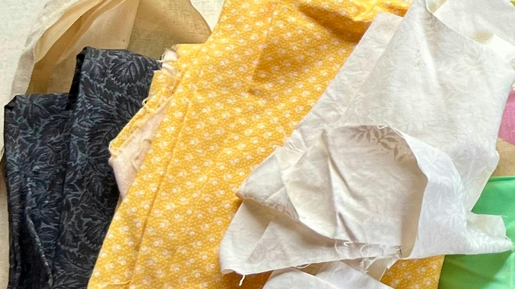 Black, white, and yellow fabrics with tiny tone on tone patterns on each.