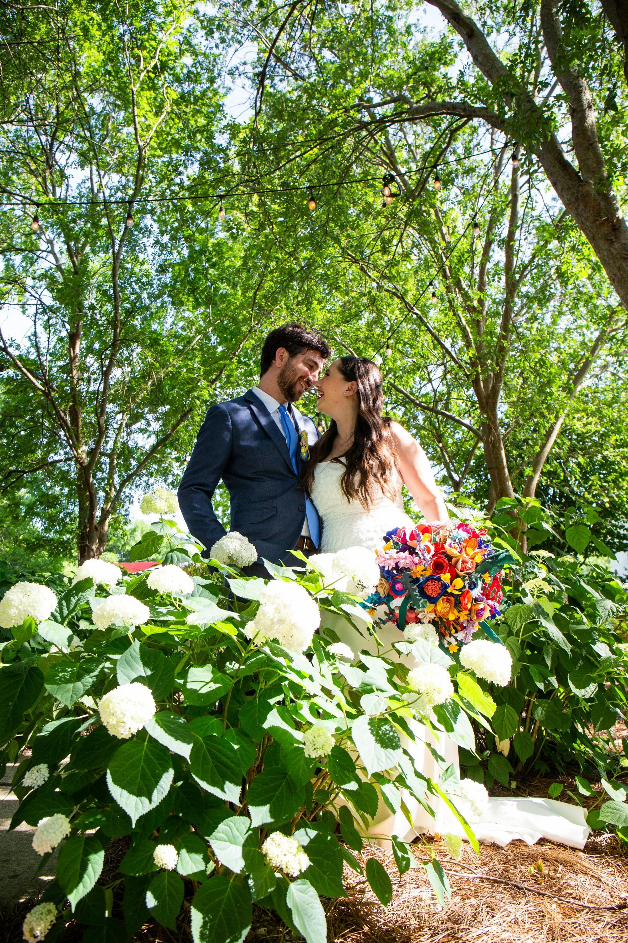 Lauren and Jake in the trees, holding the bouquet
