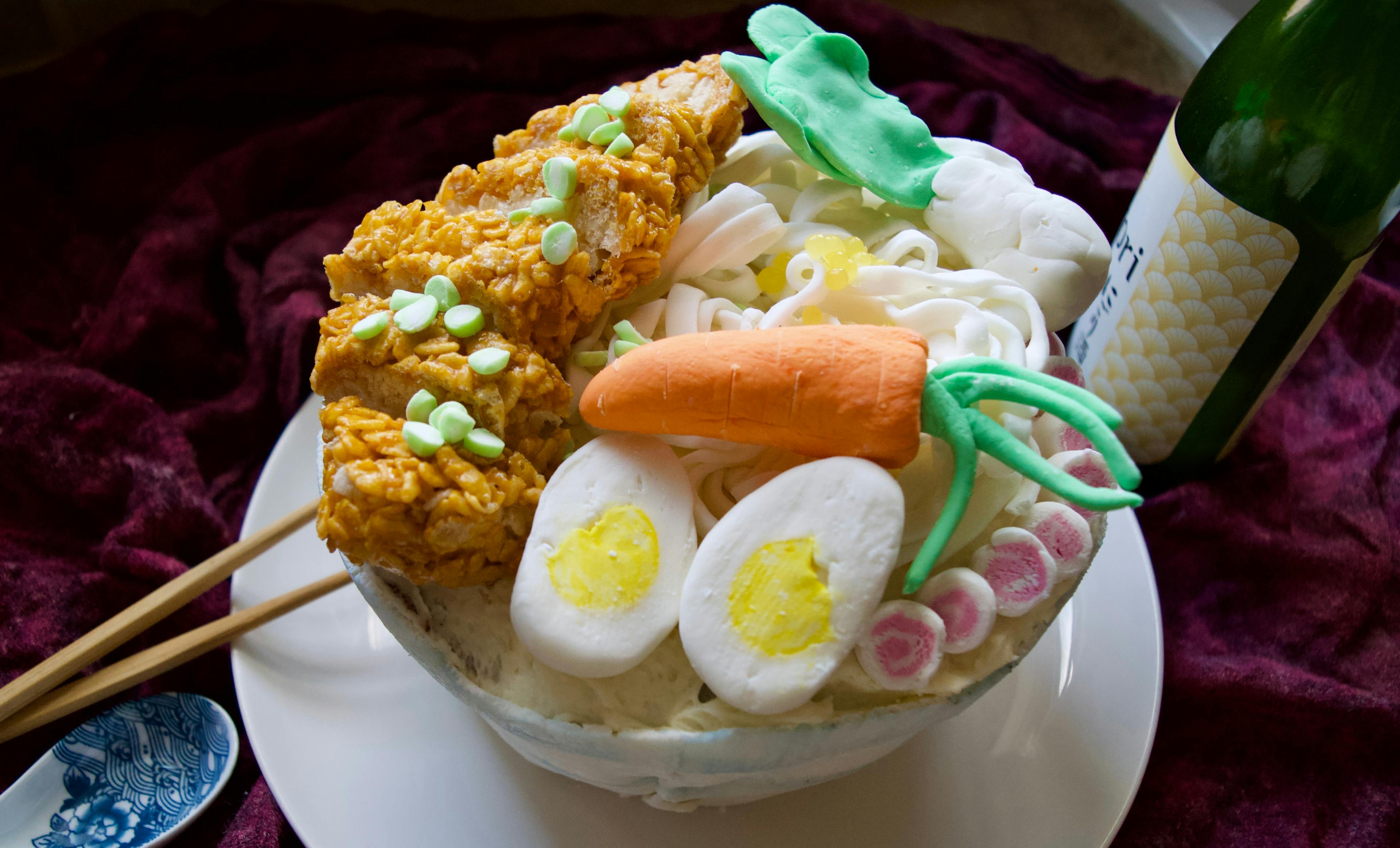 A cake decorated to look like a bowl of ramen.
