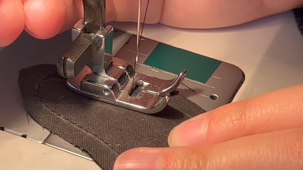 Close up of sewing the ear with the machine.