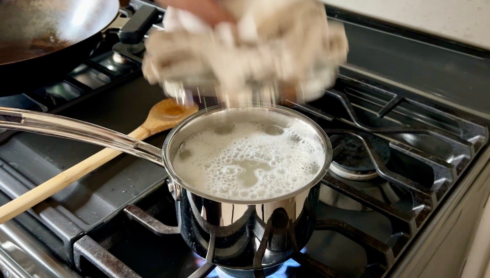 A bubbly pot of rice on the stove.