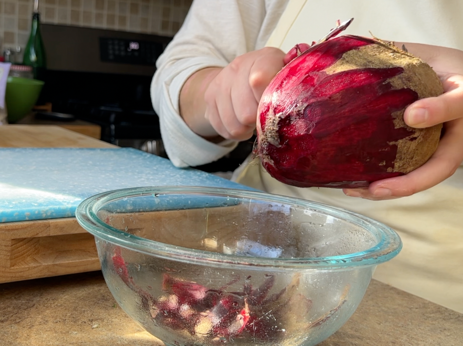Peeling a giant beet with a vegetable peeler