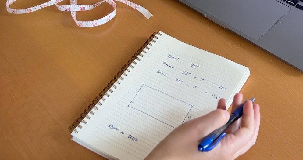 A notepad with diagrams and numbers on it