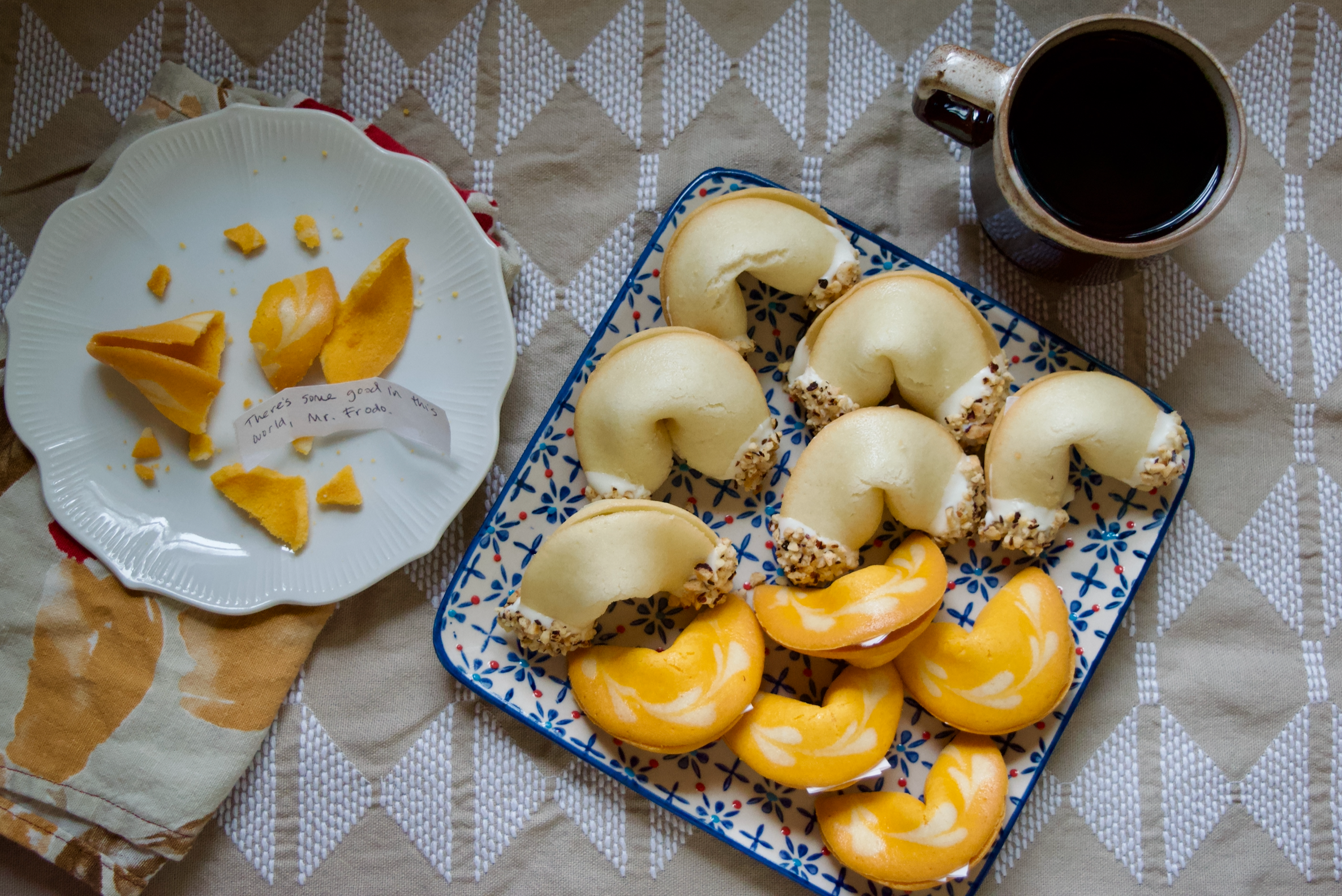 A plate of fortune cookies and a cup of tea.
