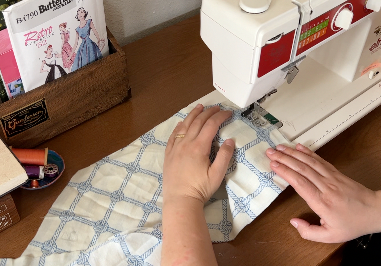 Sewing the white and blue rope fabric on the machine