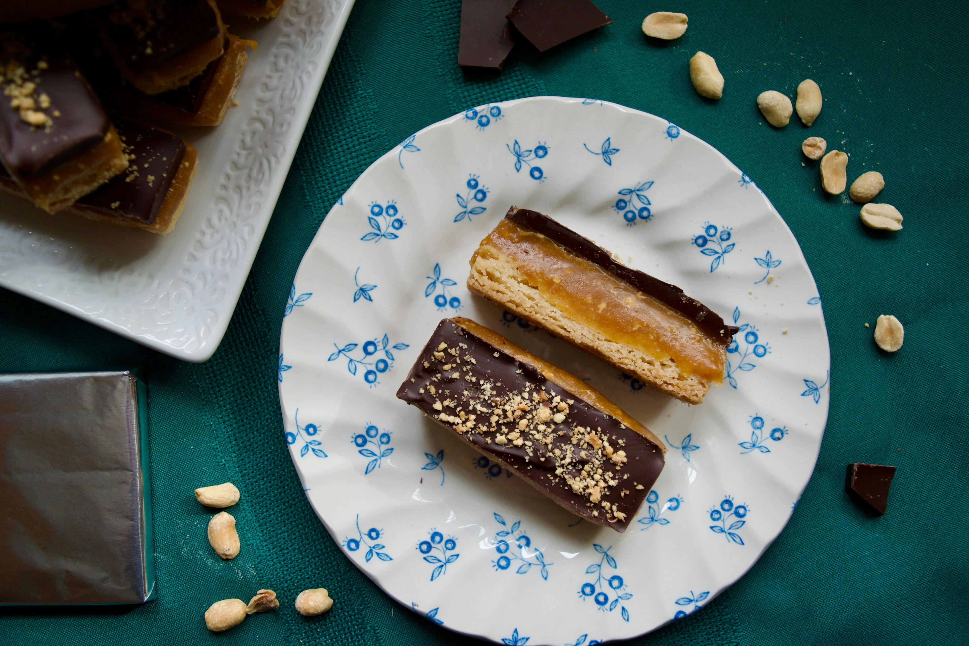 A plate of millionaire shortbreads on a green tablecloth