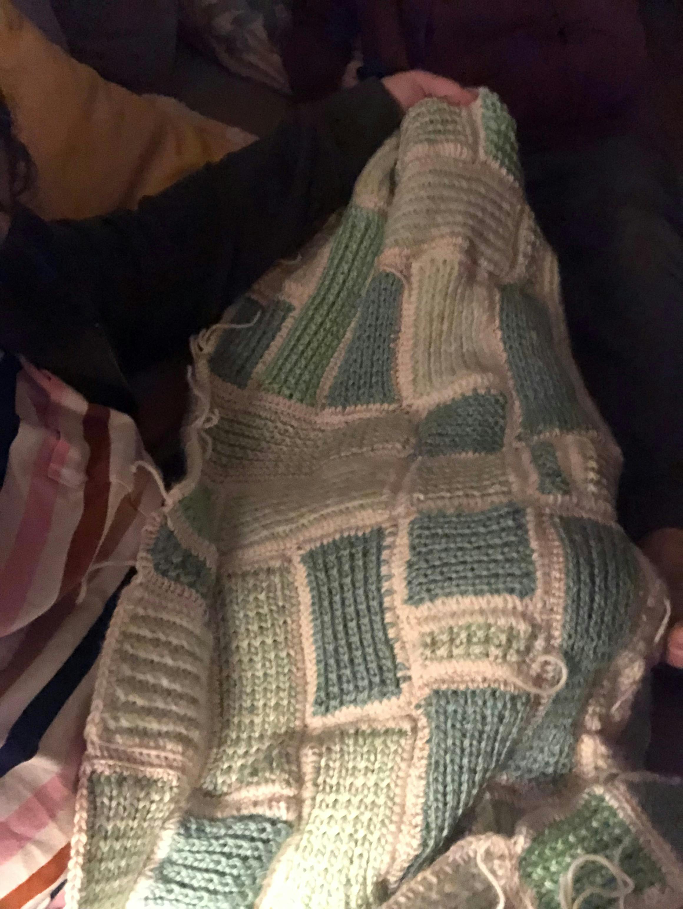 A picture of the green and white blanket I knit for Rhea's birth.