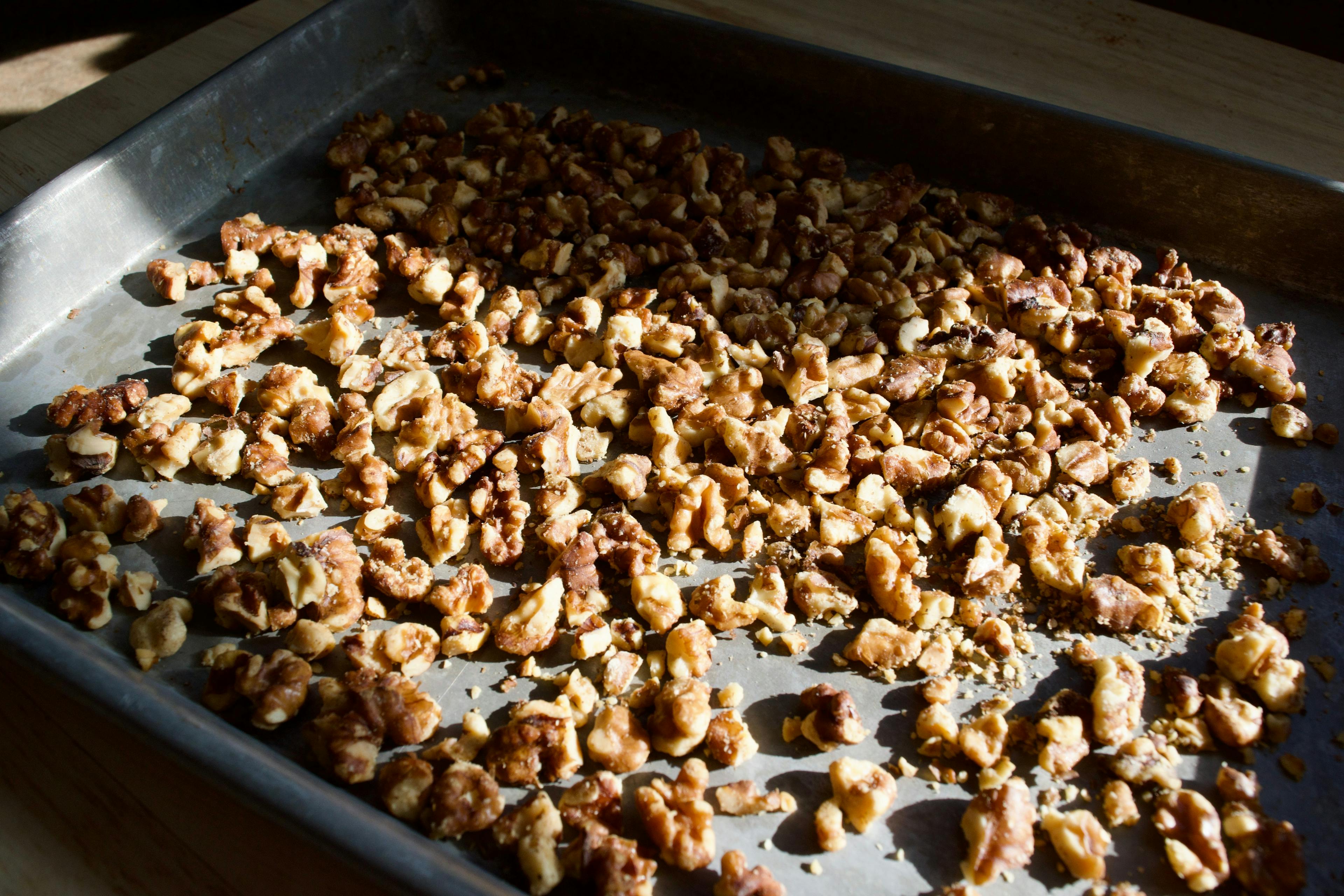 Toasted walnuts on a sheet tray