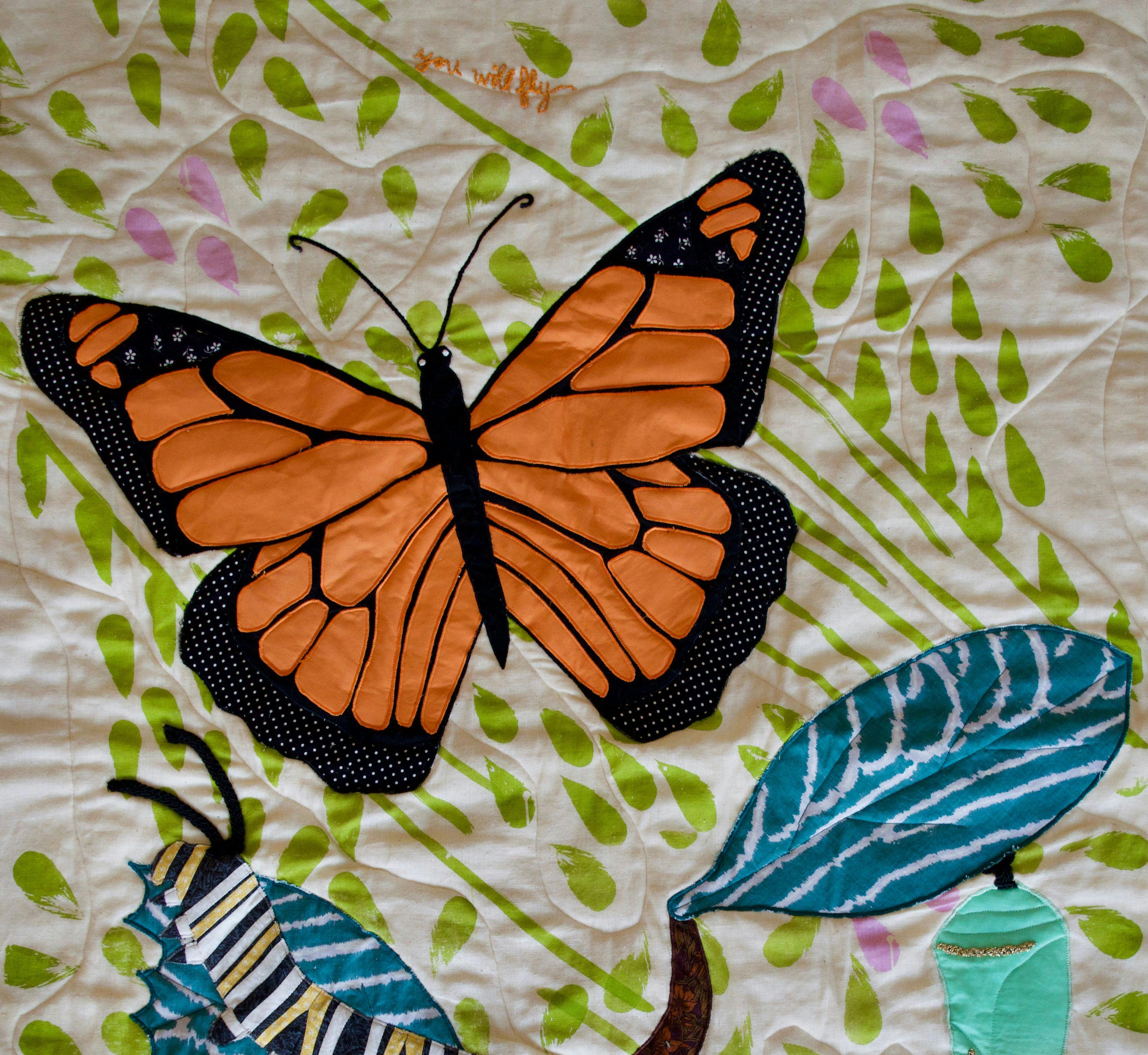 A quilt showing the life cycle of a monarch butterfly.
