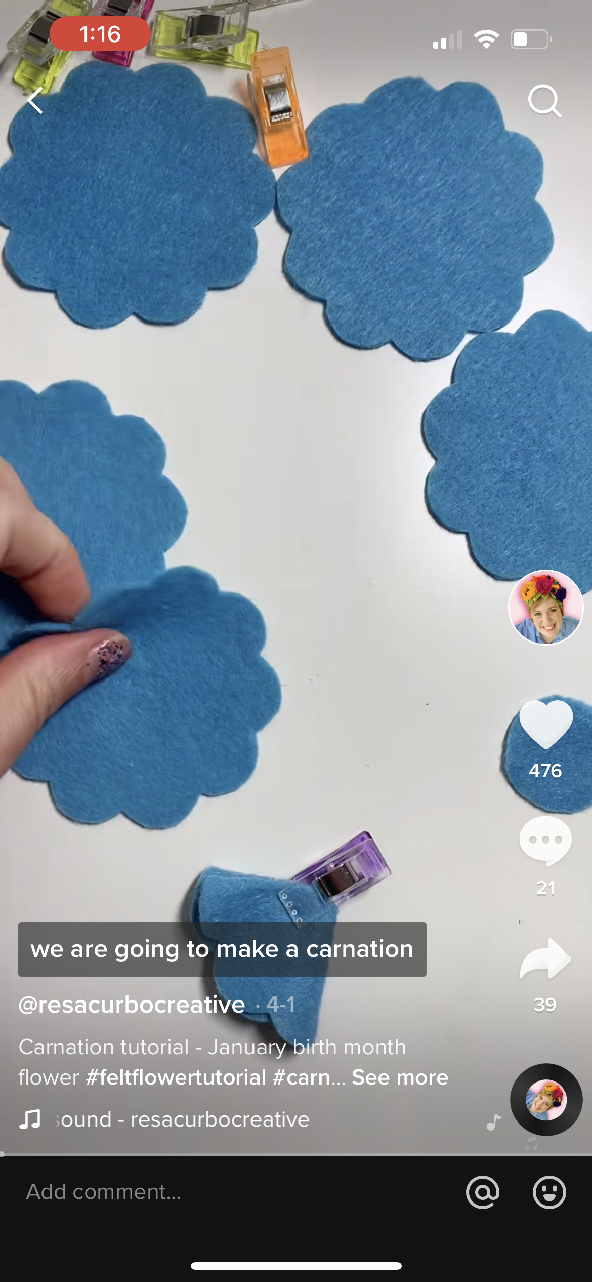 Screen shot of Resa Curbo Creative making felt flowers on TikTok. These are blue carnations.