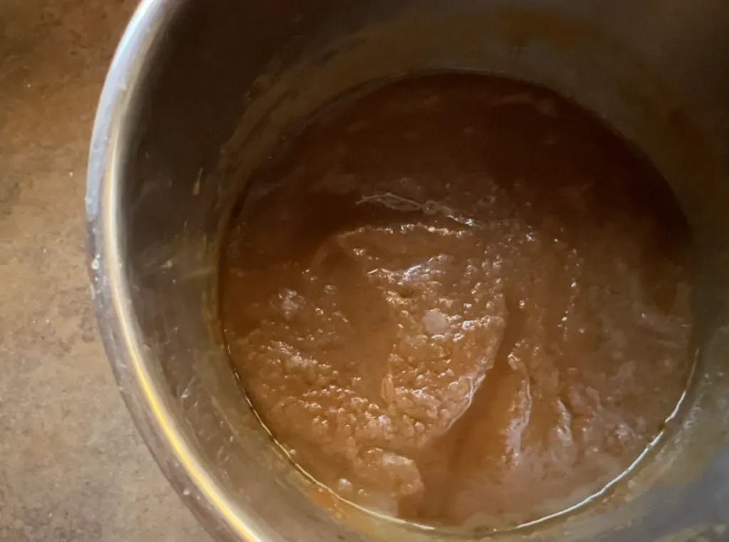 Broken oily caramel in a pan.
