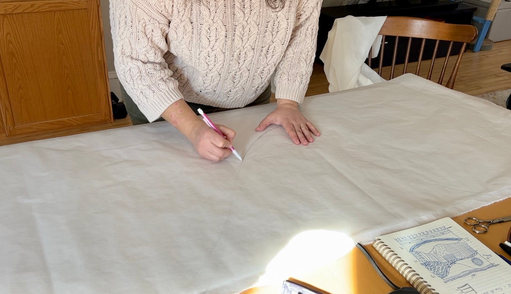 Marking the shape of the pattern pieces onto tracing paper