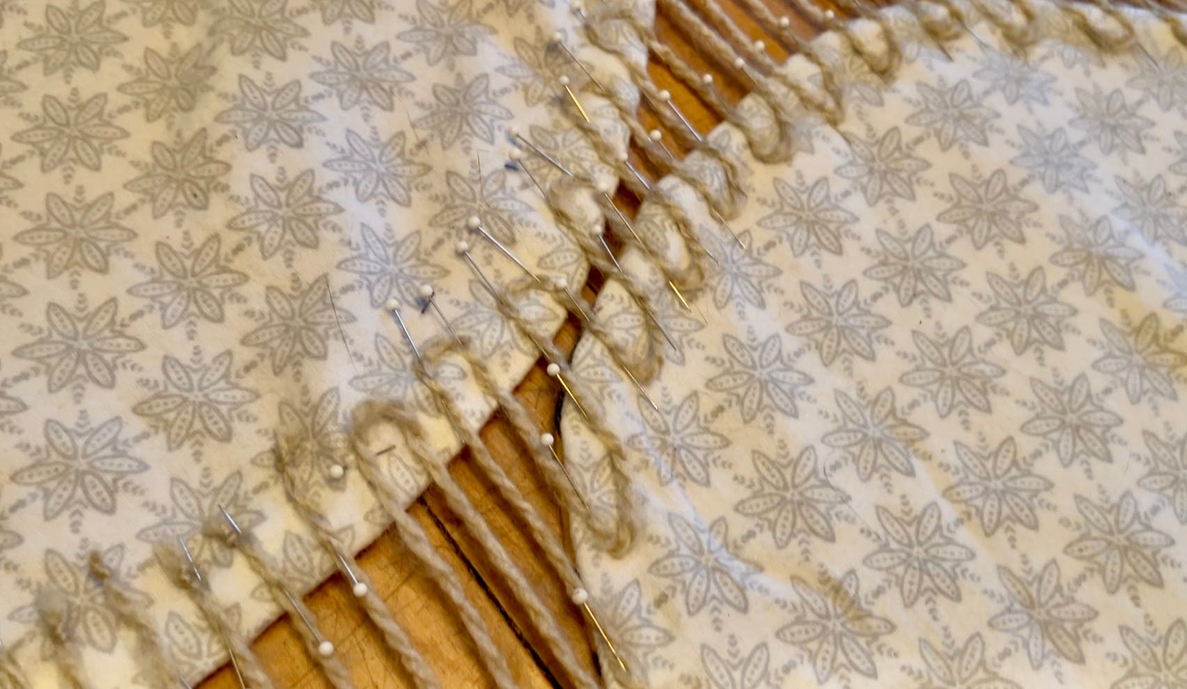 The pinned down yarn showing both methods - knotted yarns on the left and zig-zag yarn on the right