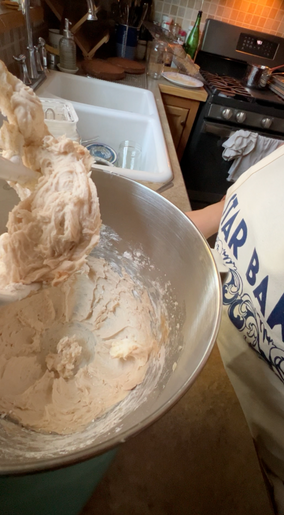 Cinnamon frosting in the bowl of a stand mixer.