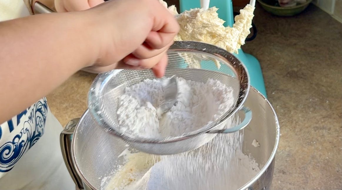 Powdered sugar being sifted.