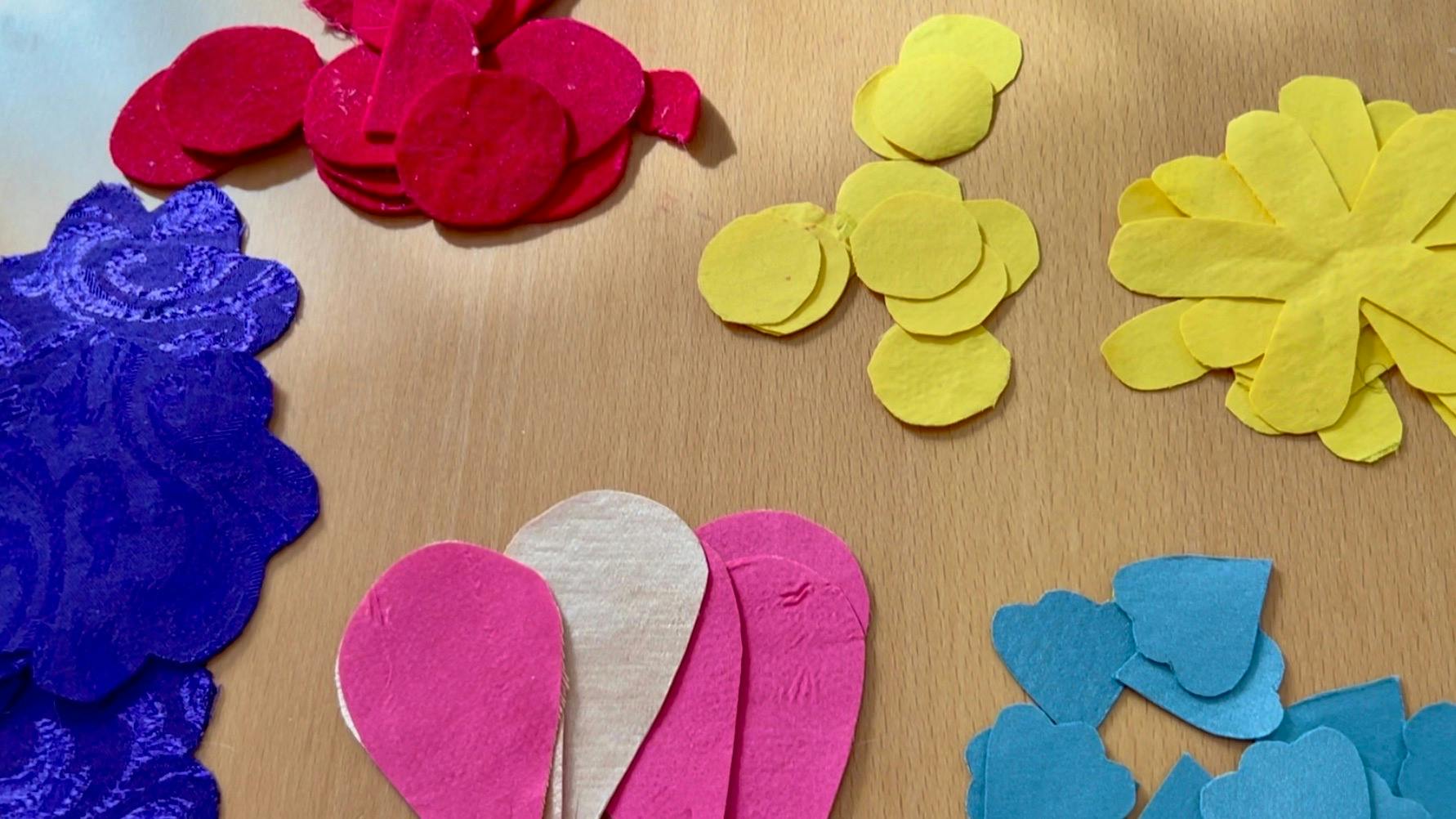 Stacks of cut out petals in multiple colors.