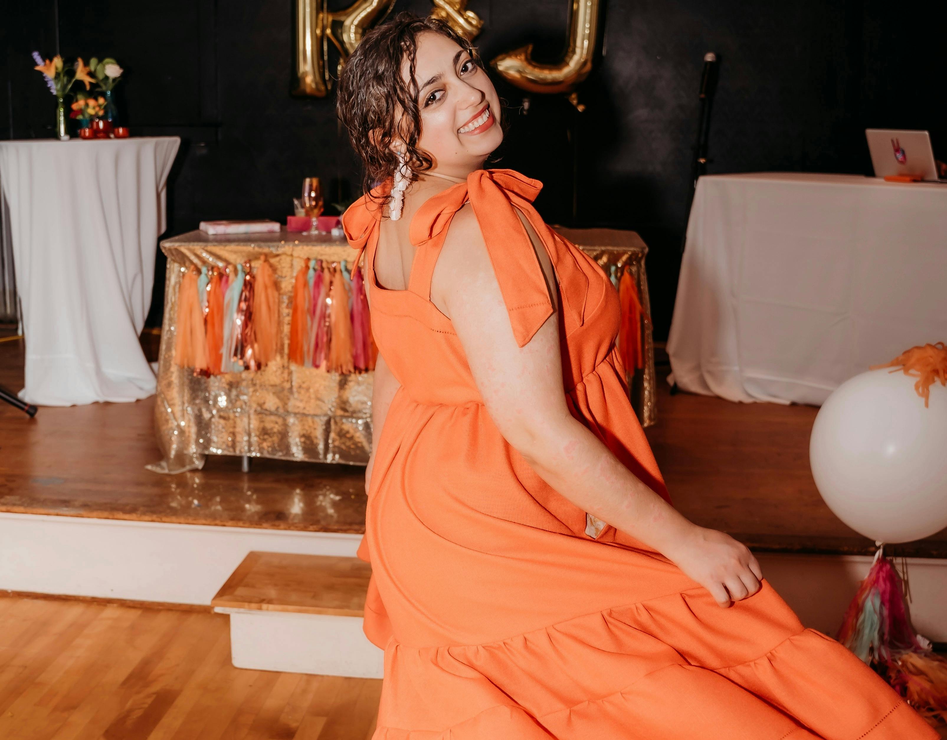 Dancing in an orange dress