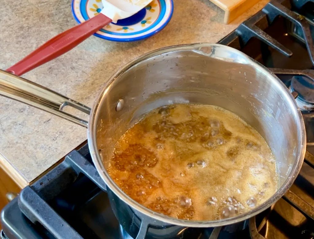 A bubbling saucepan of toffee sauce.