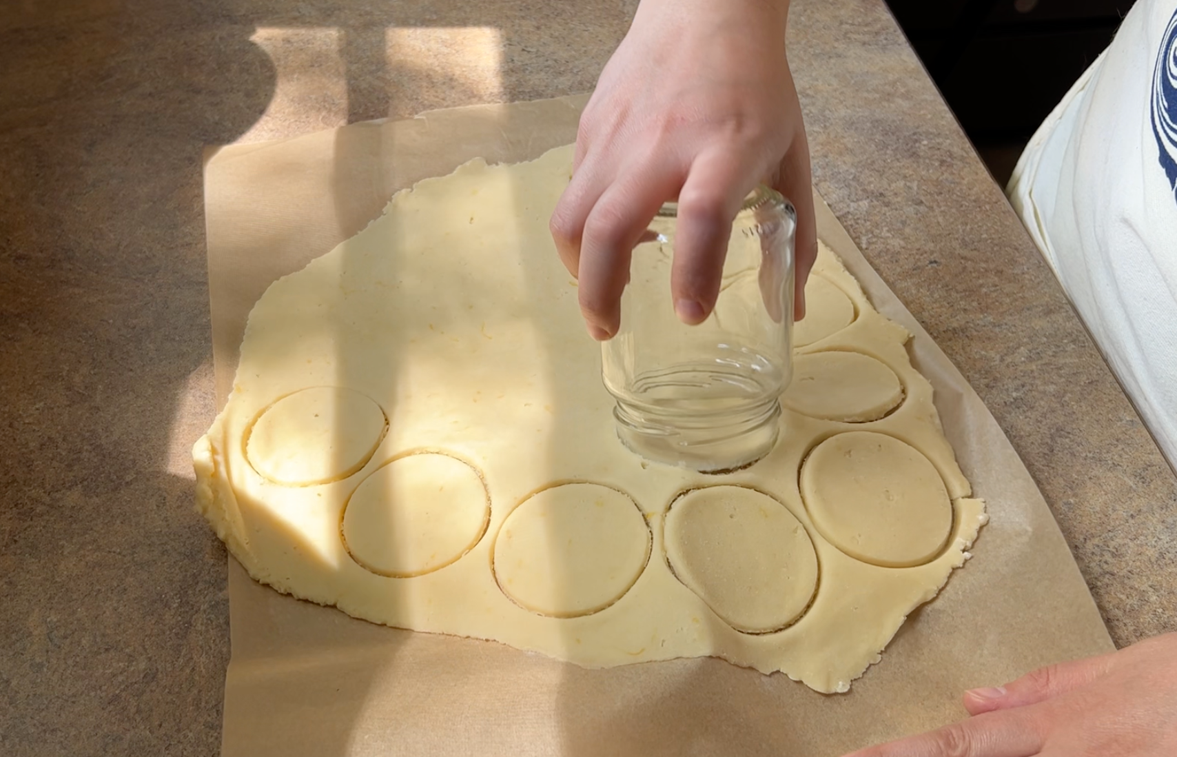 Cutting out cookie rounds.