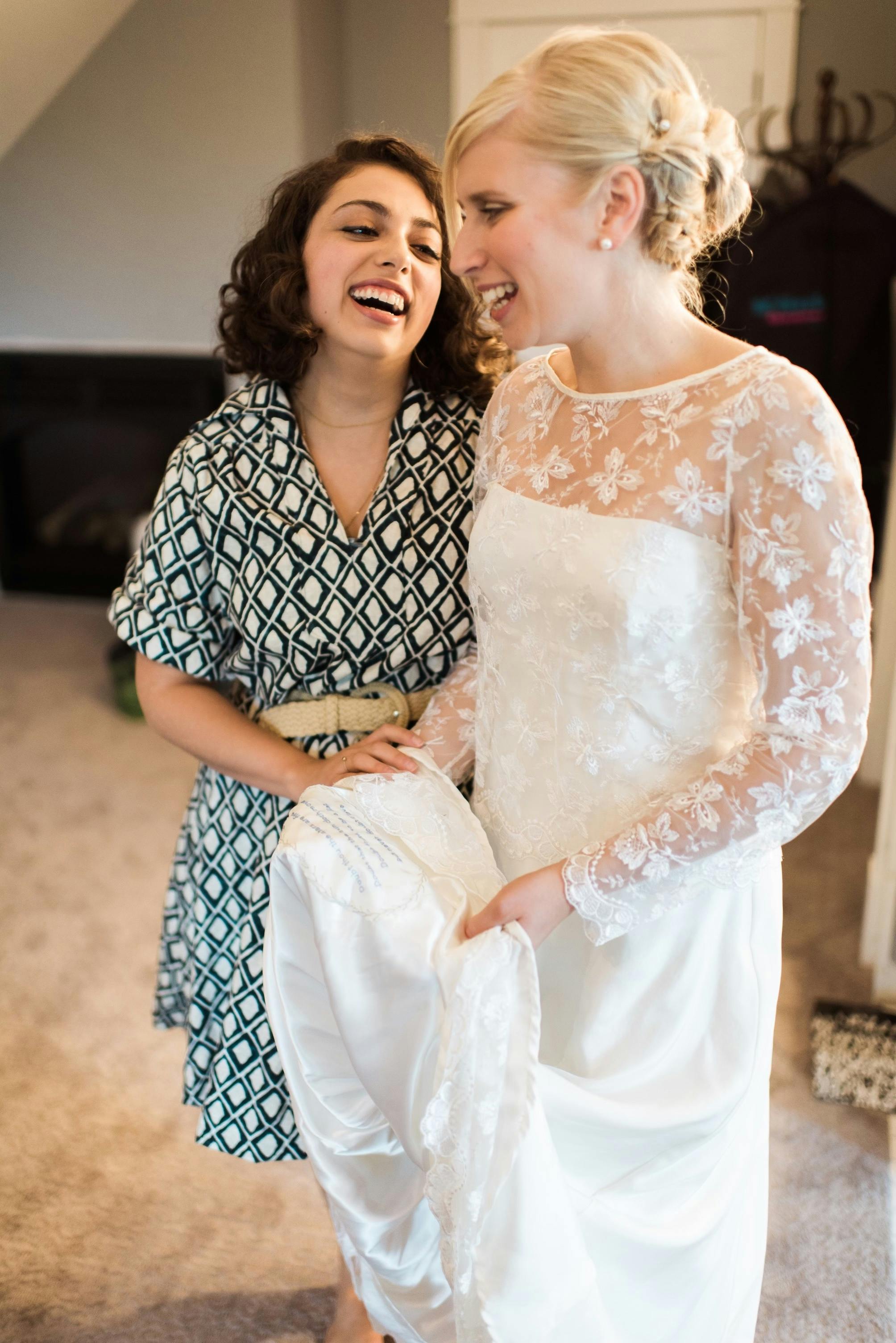 A bride in a white dress and me in a blue and white diamond patterned dress.